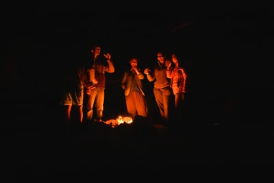 The people standing in front of the fire
